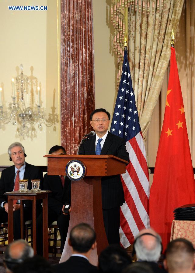 Yang Jiechi (R), Chinese State Councilor and special representative of Chinese President Xi Jinping, addresses a signing ceremony of China-U.S. EcoPartnership program in Washington, the United States, July 11, 2013. China and the United Sates on Thursday expanded their EcoPartnership program with the signing of six new partnerships to reduce greenhouse gases emissions and improve energy efficiency as well as to create jobs. (Xinhua/Wang Lei)