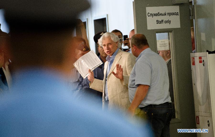 Russia lawyer Genry Reznik (C) and other representatives leave the meeting place after a meeting with former U.S. spy agency contractor Edward Snowden at Moscow's Sheremetyevo International Airport, Russia, on July 12, 2013. Edward Snowden plans to apply for political asylum in Russia, a Russian parliamentarian said Friday after meeting with the stranded whistleblower. (Xinhua/Jiang Kehong)