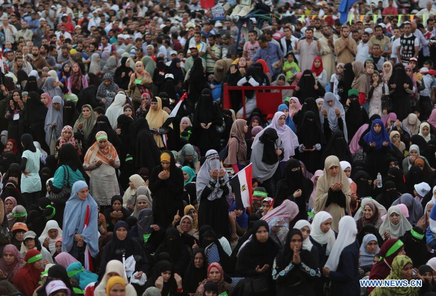 Supporters of ousted Egyptian President Mohamed Morsi pray before breaking their fast on the third day of Ramadan during a protest near the Rabaa al-Adawiya mosque, in Cairo, Egypt, July 12, 2013. (Xinhua/Wissam Nassar) 