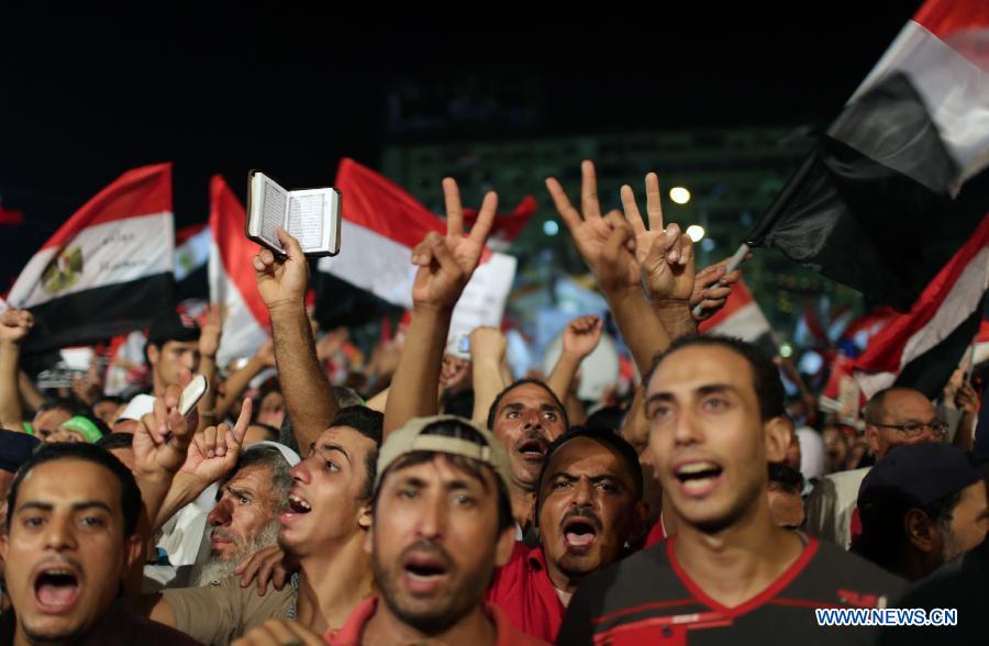 Supporters of ousted Egyptian President Mohamed Morsi pray before breaking their fast on the third day of Ramadan during a protest near the Rabaa al-Adawiya mosque, in Cairo, Egypt, July 12, 2013. (Xinhua/Wissam Nassar) 