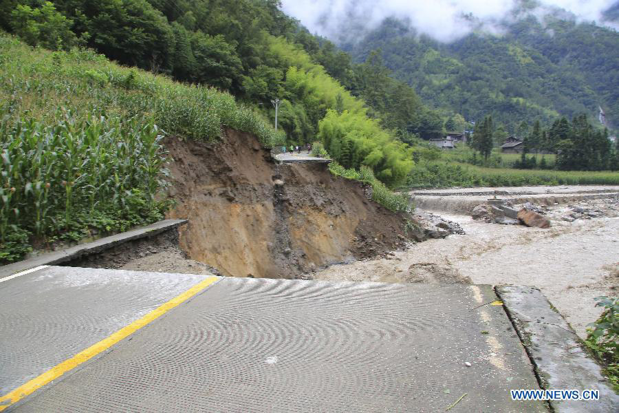 Photo taken on July 13, 2013 shows a destroyed road in Caoke Township of Shimian County in Ya'an City, southwest China's Sichuan Province. Rainstorms and floods hit Shimian County early Saturday, affecting many townships, among which Caoke Township suffered disconnection in transport, communication and electricity. No casualties have been reported yet. (Xinhua/Zhou Wanlong)