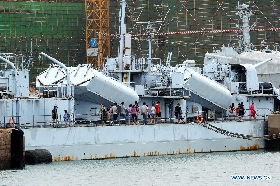 People visit a naval vessel in the Qingdao Naval Museum in Qingdao, east China's Shandong Province, July 14, 2013. Many parents took children to visit here as summer holiday began. (Xinhua/Li Ziheng) 