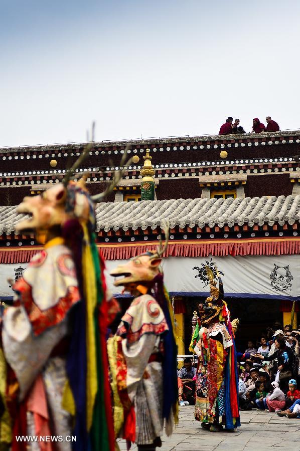 Buddhists wearing masks attend a ceremony expressing stories of Gods and ghosts in Tibetan Buddhism at the Taer Monastery in Huangzhong County of Xining, capital of northwest China's Qinghai Province, July 14, 2013. The ceremony, which is called "Tiao Qian" in Chinese, was held on Sunday here at the monastery, the birth place of Tsongkhapa, founder of the Geluk school of Tibetan Buddhism. (Xinhua/Wu Gang)