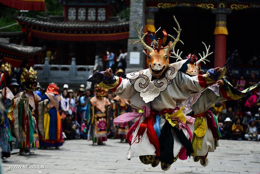 Buddhists wearing masks attend a ceremony expressing stories of Gods and ghosts in Tibetan Buddhism at the Taer (Gumbum) Monastery in Huangzhong County of Xining, capital of northwest China's Qinghai Province, July 14, 2013. The ceremony, which is called "Tiao Qian" in Chinese, was held on Sunday here at the monastery, the birth place of Tsongkhapa, founder of the Geluk school of Tibetan Buddhism. (Xinhua/Wu Gang)