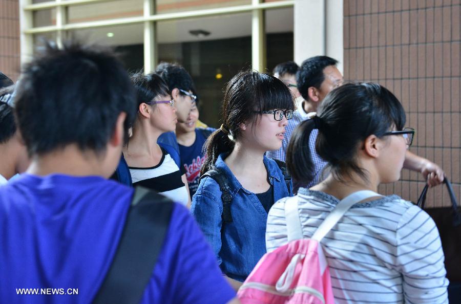 Survivors of a fatal plane crash that occurred in San Francisco on July 6 wait at the exit of the Hangzhou Railway Station in Hangzhou, capital of east China's Zhejiang Province, July 14, 2013. The returnees are students and teachers from Jiangshan Middle School who traveled with a 34-member group to the U.S. to attend a summer camp. (Xinhua/Long Wei)