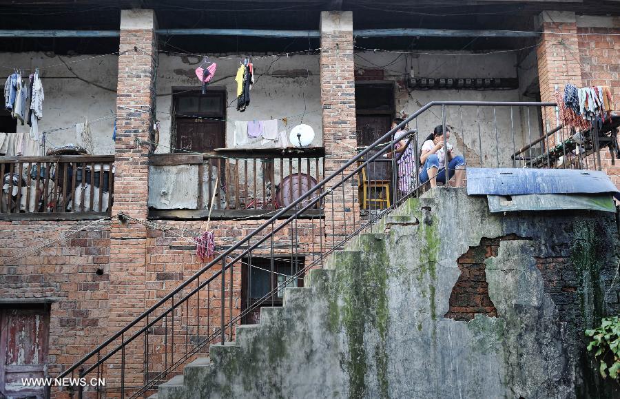 A young lady has dinner at home in the Miao Autonomous County of Chengbu, central China's Hunan Province, July 13, 2013. An ecology tourism festival is held here from July 12 to 14. (Xinhua/Cheng Tingting)  