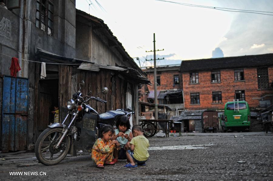 Kids play together in the Miao Autonomous County of Chengbu, central China's Hunan Province, July 13, 2013. An ecology tourism festival is held here from July 12 to 14. (Xinhua/Cheng Tingting) 