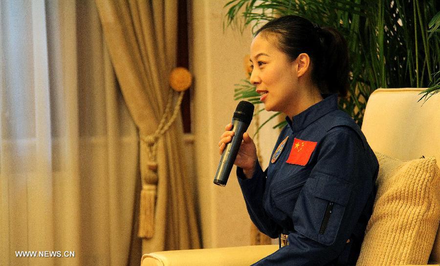 Wang Yaping, astronaut of China's Shenzhou-10 mission, answers questions at a press conference in Beijing, China, July 11, 2013. Nie Haisheng, Zhang Xiaoguang and Wang Yaping, the three astronauts of China's Shenzhou-10 mission, have completed their medical quarantine and are in good conditions, according to official sources. (Xinhua/Liu Fang)