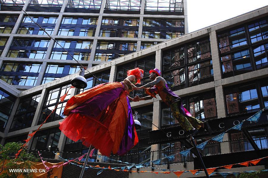 Lindsey Shepek (R) and Keely Sills dance "Wobble Tops" 15 feet off the ground during the 25th annual Dancing on the Edge international festival in Vancouver, Canada, July 11, 2013. A total of 28 different choreographers and dance companies from around the world will entertain audience during this year's festival. (Xinhua/Sergei Bachlakov)