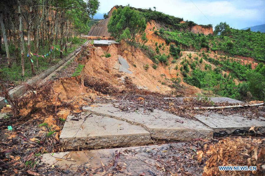 Photo taken on July 14, 2013 shows a broken road in Fengshun County in Meizhou City, south China's Guangdong Province. Typhoon Soulik-triggered rainstorms battered Meizhou from Saturday night, flooding many roads and farmlands. (Xinhua/Zhong Xiaofeng)