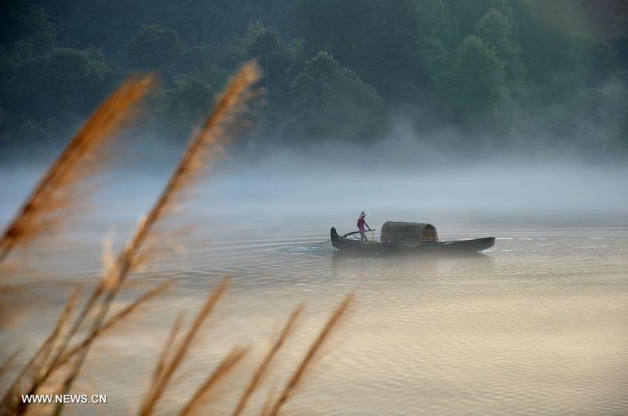 A fisherman fishes on the Xiaodongjiang River in Zixing City, central China's Hunan Province, July 7, 2013. (Xinhua/He Maofeng)