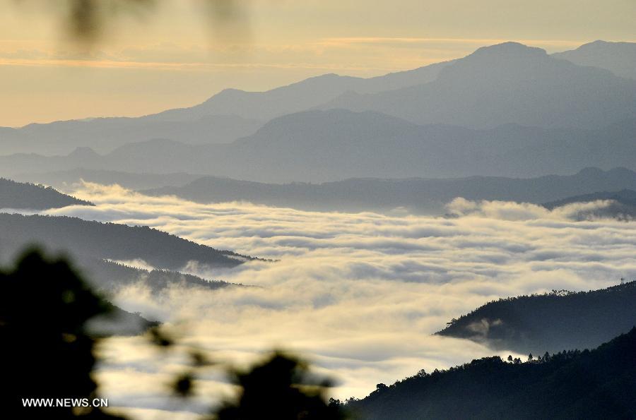 Photo taken on July 13, 2013 shows the mountains of the Bawangling National Nature Reserve in south China's Hainan Province. The Bawangling National Nature Reserve is the only nature reserve in China that protects Hainan Gibbons, a highly endangered species that is under first-class state protection. With the advent of three gibbon babies in the first seven months in 2013, the population of the gibbons has risen to 26 here. (Xinhua/Jiang Enyu)