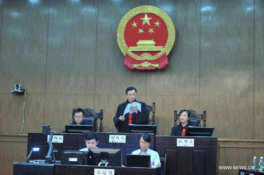 Photo taken on July 15, 2013 shows the judge reading the final ruling in the The Hunan Provincial People's High Court in Changsha, capital of central China's Hunan Province. The Hunan Provincial People's High Court on Monday ordered the Yongzhou municipal re-education through labor commission to pay Tang Hui 2,941 yuan (478 U.S. dollars) in compensation for infringing upon her personal freedom and causing mental damages. The 40-year-old mother appealed to the high court in April after the Yongzhou Intermediate People's Court denied her request for an apology and compensation from the re-education through labor commission. Tang was put into the labor camp after she publicly petitioned for harsher punishments for those found guilty of raping her daughter and forcing her into prostitution. (Xinhua/Long Hongtao) 