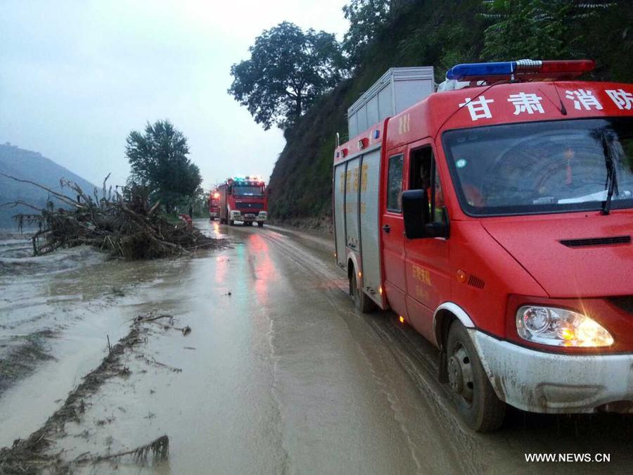 Photo taken on July 15, 2013 shows a collapsed road destroyed by a rain-triggered floods in Fanjiachuan Village of Qingyang City, northwest China's Gansu Province. Two people were killed, one was injured and six others were reported missing in the rain-triggered floods. Rescue work is underway. (Xinhua/Li Pengbo) 