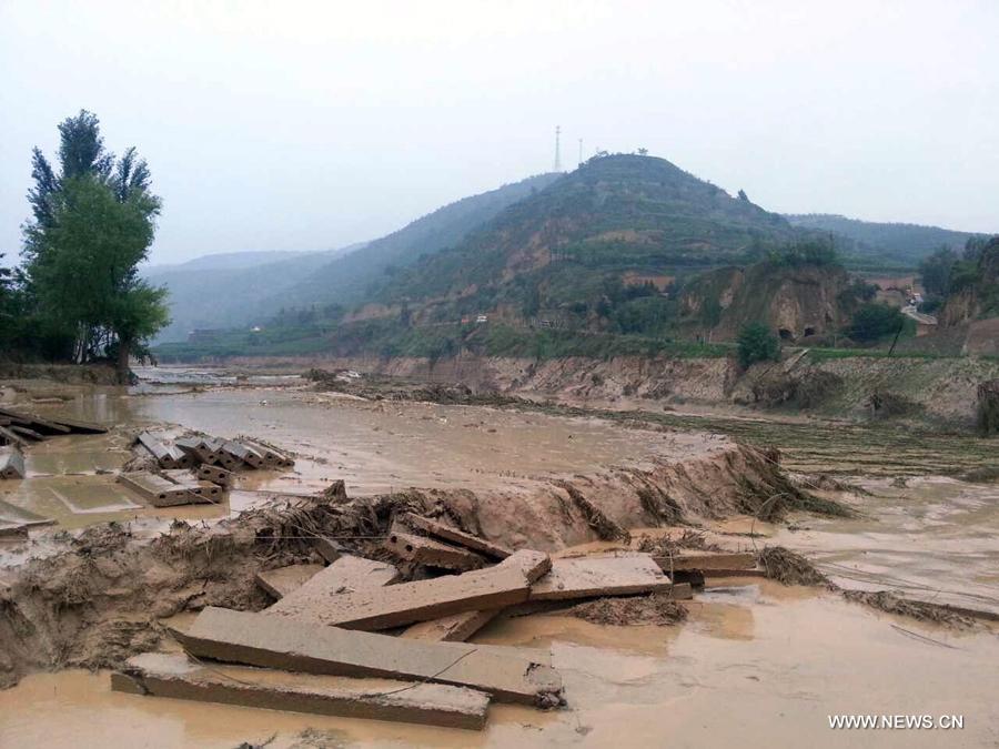 Photo taken on July 15, 2013 shows a farmland destroyed by a rain-triggered floods in Fanjiachuan Village of Qingyang City, northwest China's Gansu Province. Two people were killed, one was injured and six others were reported missing in the rain-triggered floods. Rescue work is underway. (Xinhua/Li Pengbo) 