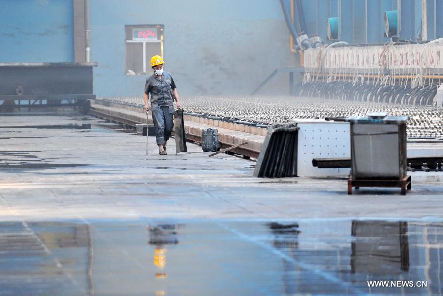 Photo taken on June 29, 2013 shows a worker working in a mineral company in Xiushan County, southwest China's Chongqing. China's gross domestic product (GDP) totaled 24.8 trillion yuan (4 trillion U.S. dollars) in the first half of 2013, with the growth at 7.6 percent, which is in line with market expectations and was above the government's full-year target of 7.5 percent, data from China's National Bureau of Statistics (NBS) showed on July 15, 2013. (Xinhua/Chen Yehua)