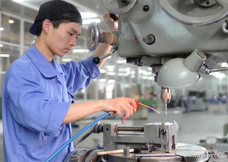 A worker does his job in production plant in Gu'an, north China's Hebei Province, April 23, 2013. China's gross domestic product (GDP) totaled 24.8 trillion yuan (4 trillion U.S. dollars) in the first half of 2013, with the growth at 7.6 percent, which is in line with market expectations and was above the government's full-year target of 7.5 percent, data from China's National Bureau of Statistics (NBS) showed on July 15, 2013.(Xinhua/Wang Xiao)