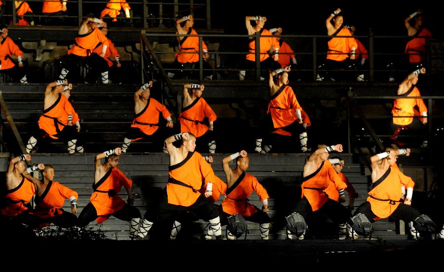 Actors perform in the music ritual in Zhengzhou, capital of central China's Henan Province, July 14, 2013. The real scene show "Shaolin Zen Music Ritual" has run for more than 1,600 performances since its premiere in May, 2007. The music ritual was shown on the natural stage of the Songshan Mountain to present a rhythm combined with natural sounds and the "Zen Music". (Xinhua/Zhu Xiang) 