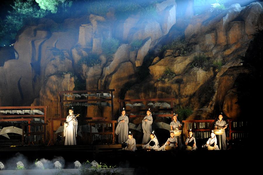 Actors perform in the music ritual in Zhengzhou, capital of central China's Henan Province, July 14, 2013. The real scene show "Shaolin Zen Music Ritual" has run for more than 1,600 performances since its premiere in May, 2007. The music ritual was shown on the natural stage of the Songshan Mountain to present a rhythm combined with natural sounds and the "Zen Music". (Xinhua/Zhu Xiang) 