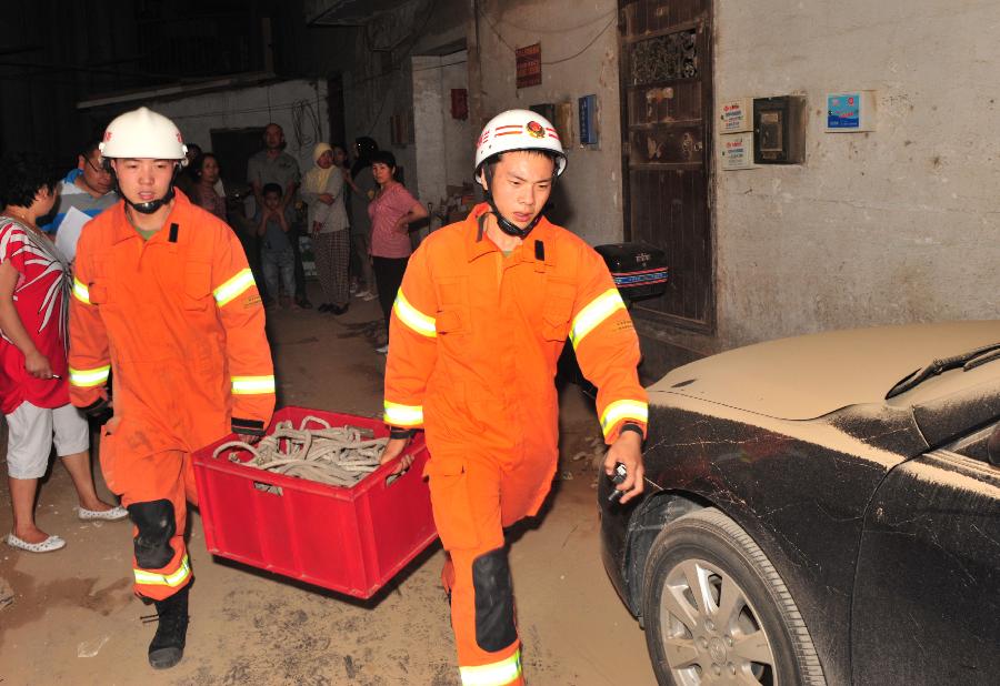 Rescuers work at the landslide site in Chengguan District of Lanzhou City, northwest China's Gansu Province, July 15, 2013. Two landslides happened in Lanzhou on Monday due to the continuous rainfalls, leaving dozens people trapped. The rescue work is underway. (Xinhua/Liang Qiang) 