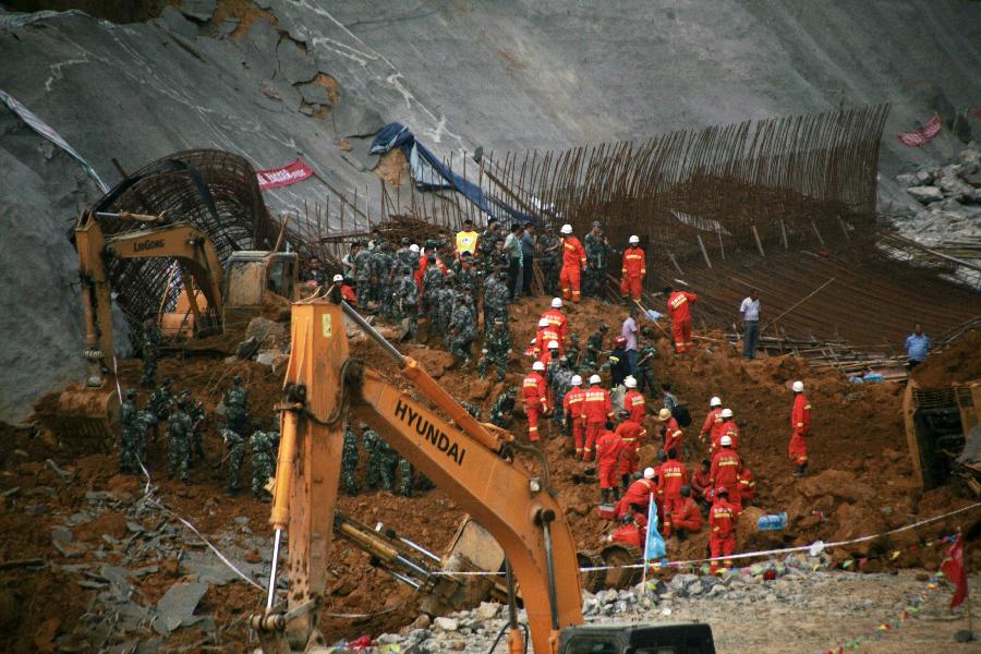 Rescuers work at a landslide site in Qixingguan District of Bijie City, southwest China's Guizhou Province, July 15, 2013. The landslide happened around 3:00 p.m., burying six people in total. Among the four people who were found, three were killed and one injured. (Xinhua)