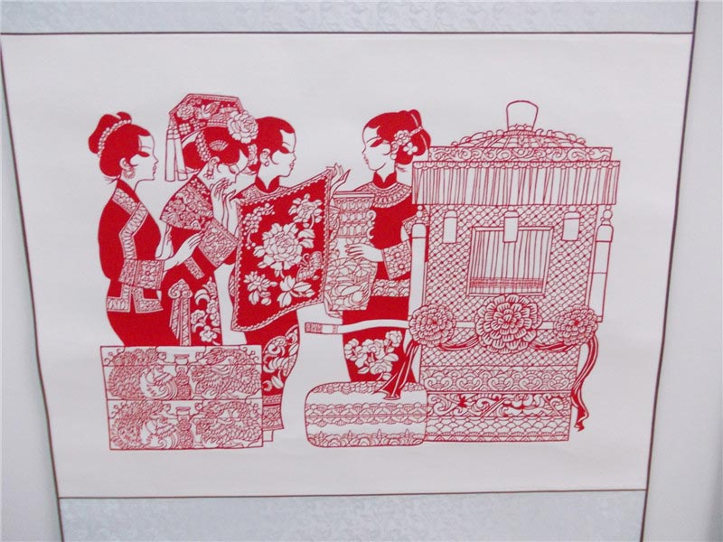 A paper-cut design depicting Manchu wedding customs displayed at the 4th Chinese paper-cut art festival in Wei county, Hebei province. The festival was held July 8-10 and featured works from over 360 folk artists around China. (China Daily/Tang Zhe)