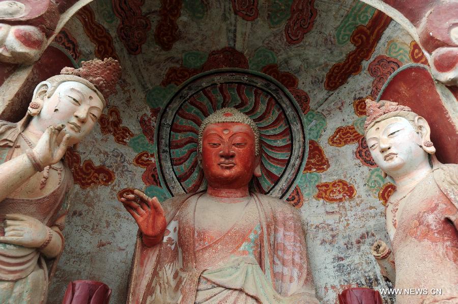 Photo taken on July 15, 2013 shows sculptures at the Maiji Mountain Grottoes in Tianshui, northwest China's Gansu Province. After protection and preparation, the Maiji Mountain Grottoes, the fourth largest grottoes in China and known as the "Oriental Sculpture Museum", has been ready for the application for status on the World Heritage List in 2014, as a part of the application program of the 2,000-year-old Silk Road which China works with Kazakstan and Kyrgyzstan and was officially submitted to the United Nations Educational, Scientific and Cultural Organization (UNESCO) in January of 2013. China has altogether 22 historical sites in this application program, including seven in Xinjiang, five in Gansu, six in Shaanxi and four in Henan. (Xinhua/Nie Jianjiang) 