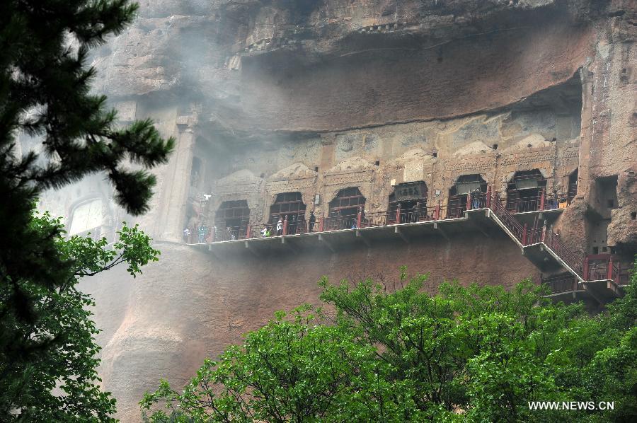Photo taken on July 15, 2013 shows the scenery at the Maiji Mountain Grottoes in Tianshui, northwest China's Gansu Province. After protection and preparation, the Maiji Mountain Grottoes, the fourth largest grottoes in China and known as the "Oriental Sculpture Museum", has been ready for the application for status on the World Heritage List in 2014, as a part of the application program of the 2,000-year-old Silk Road which China works with Kazakstan and Kyrgyzstan and was officially submitted to the United Nations Educational, Scientific and Cultural Organization (UNESCO) in January of 2013. China has altogether 22 historical sites in this application program, including seven in Xinjiang, five in Gansu, six in Shaanxi and four in Henan. (Xinhua/Nie Jianjiang) 