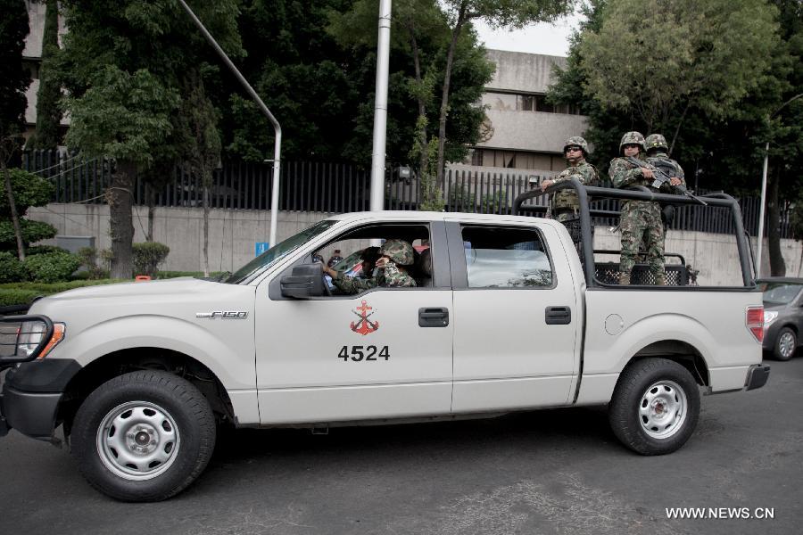 Elements of the Mexican Navy watch over the Assistant Attorney General's Office for Special Investigations on Organized Crime (SEIDO, for its Spanish acronym) after the capture of the aleged Drug Lord, Miguel Angel Trevino Morales, in Mexico City, Mexico, on July 16, 2013. The leader of the Zetas' Cartel, Miguel Angel Trevino Morales, also known as the Z-40, was captured on Monday's morning by members of the Mexican Navy, near Nuevo Laredo, Tamaulipas, according to a Mexican government spokesman. (Xinhua/Alejandro Ayala) 