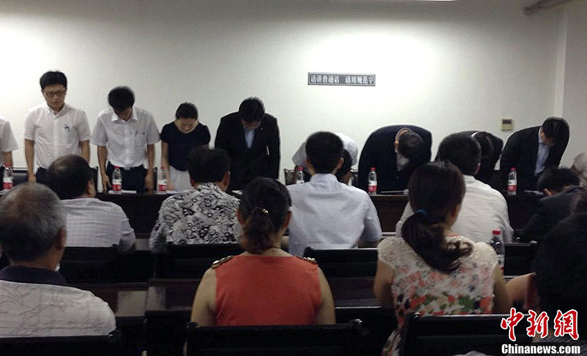 A senior executive with Asiana Airlines and the company’s representatives bow to student’s parents to apologize for the crash in San Francisco in Jiangshan, Zhejiang province, July 17, 2013.(Shao Yanfei/CNS)