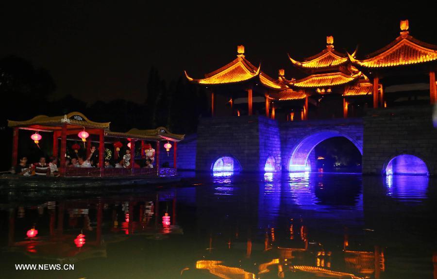 Photo taken on July 17, 2013 shows the night view of the Slender West Lake in Yangzhou, east China's Jiangsu Province. The night tour for visiting the Slender West Lake opened here on Wednesday. (Xinhua/Dong Hui)