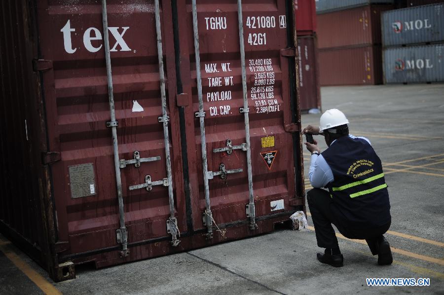 An investigation officer inspects a container with military equipments aboard the "Chong Chon Gang" vessel from the Democratic People's Republic of Korea (DPRK), at the Manzanillo International container terminal on the coast of Colon City, Panama, July 17, 2013. The Democratic People's Republic of Korea (DPRK) on Thursday demanded the release of a vessel seized in Panama suspected of carrying narcotic drugs and banned arms, claiming the weapons were being transported under a legitimate contract with Cuba, the official KCNA news agency reported. (Xinhua/Mauricio Valenzuela)