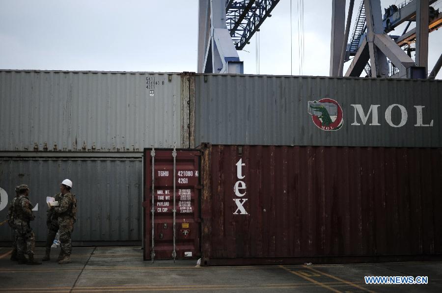 Investigation officers inspect a container with military equipments aboard the "Chong Chon Gang" vessel from the Democratic People's Republic of Korea (DPRK), at the Manzanillo International container terminal on the coast of Colon City, Panama, July 17, 2013. The Democratic People's Republic of Korea (DPRK) on Thursday demanded the release of a vessel seized in Panama suspected of carrying narcotic drugs and banned arms, claiming the weapons were being transported under a legitimate contract with Cuba, the official KCNA news agency reported. (Xinhua/Mauricio Valenzuela)