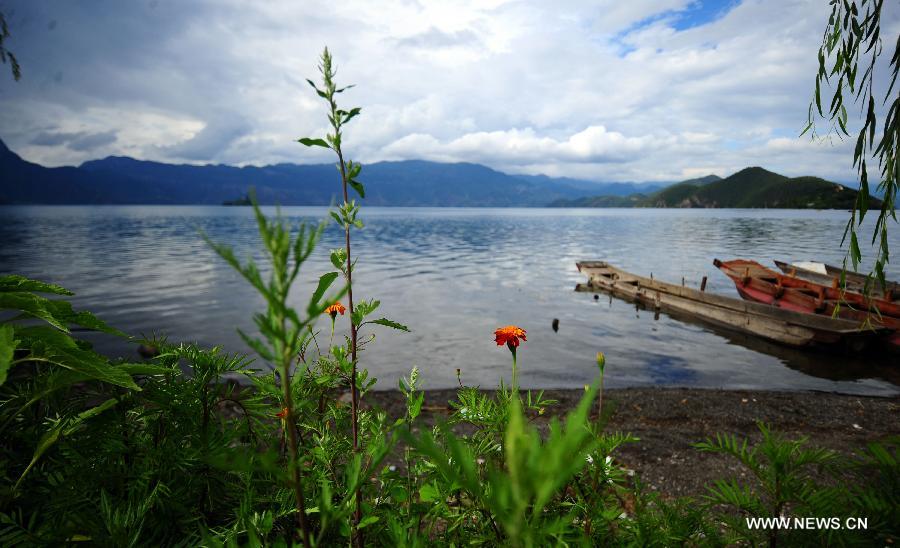 Photo taken on July 17, 2013 shows the scenery at the Lugu Lake in the Yi Autonomous County of Ninglang, southwest China's Yunnan Province. Lugu is renowned for its beautiful scenery and the maintenance of the unique matriarchal system observed by the indigenous Mosuo people. (Xinhua/Qin Lang)