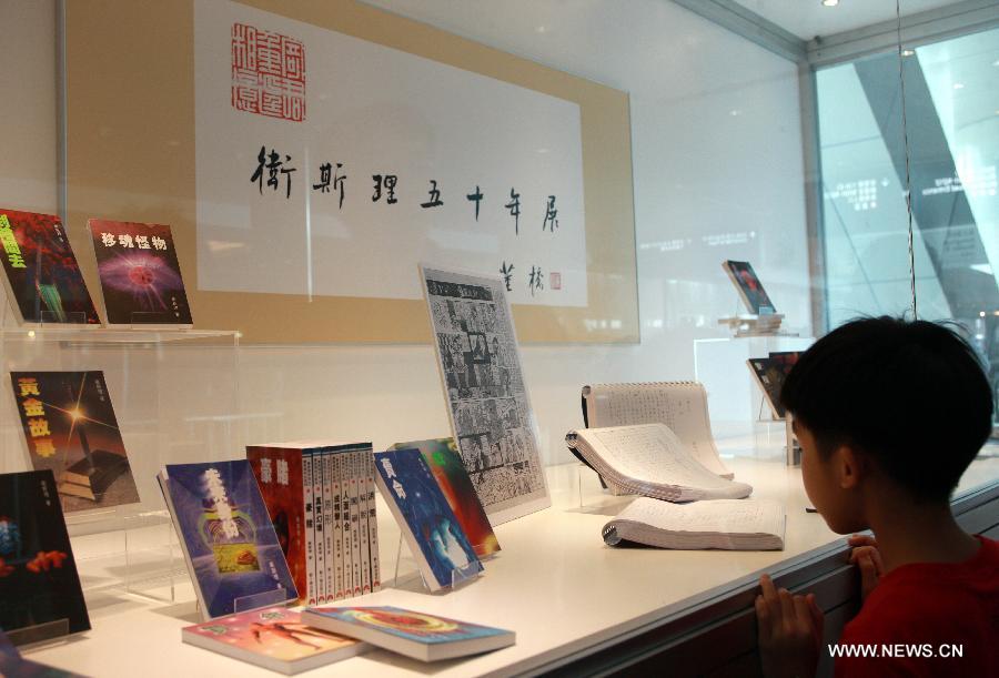 A boy visits an exhibition marking the 50th annivesary of the birth of Wesley, the main character in a series of science fictions written by novelist Ni Kuang, during the 24th Hong Kong Book Fair in south China's Hong Kong, July 18, 2013. The seven-day book fair, which kicked off Wednesday at Hong Kong Convention and Exhibition Center, attracted 560 exhibitors from 30 countries and regions. (Xinhua/Jin Yi)