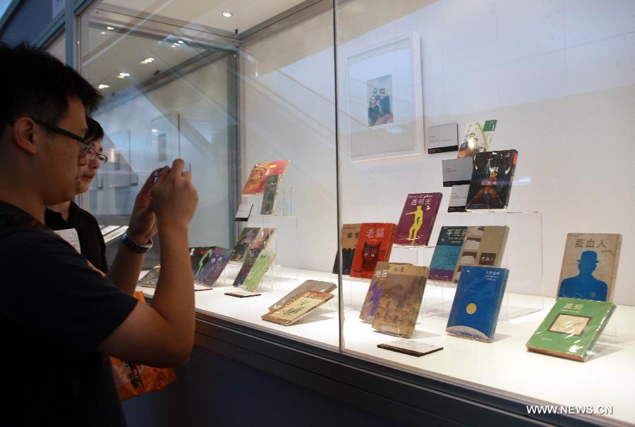 People visit an exhibition marking the 50th annivesary of the birth of Wesley, the main character in a series of science fictions written by novelist Ni Kuang, during the 24th Hong Kong Book Fair in south China's Hong Kong, July 18, 2013. The seven-day book fair, which kicked off Wednesday at Hong Kong Convention and Exhibition Center, attracted 560 exhibitors from 30 countries and regions. (Xinhua/Jin Yi)