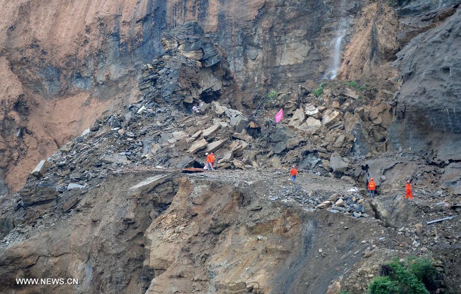 Workers place explosives at a blasting site above a barrier lake in Sanjiao Township of Hanyuan County, southwest China's Sichuan Province. The blasting is conducted to remove dangerous rocks and then dig channels to discharge the floodwater of the barrier lake. The lake was formed after a landslide and continuous rainfall, threatening residents downstream in Sichuan. (Xinhua/Xue Yubin) 