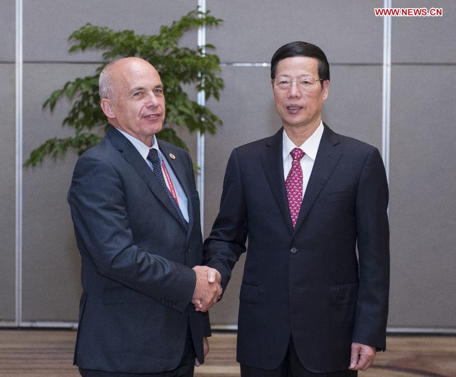 Chinese Vice Premier Zhang Gaoli (R), also a member of the Standing Committee of the Political Bureau of the Communist Party of China Central Committee, shakes hands with Swiss President Ueli Maurer during their meeting at the Eco-Forum Global in Guiyang, capital of southwest China's Guizhou Province, July 19, 2013. The Eco-Forum Global is held from July 19 to July 21. (Xinhua/Wang Ye)