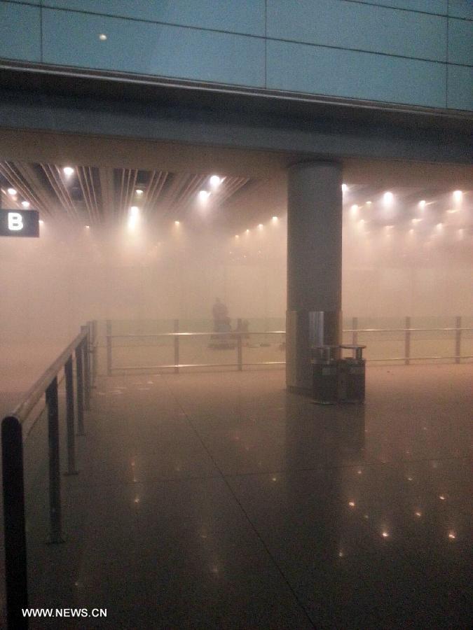 Photo taken on July 20, 2013 with a cellphone shows the site of an explosion at Terminal 3 of the Beijing Capital International Airport in Beijing, capital of China. Ji Zhongxing, a 34-year-old from Heze City of east China's Shandong Province, set off a home-made explosive device outside the arrivals exit of the Terminal 3 at around 6:24 p.m. Saturday after he was stopped from handing out leaflets to get attention to his complaints, an initial police investigation showed. Ji suffered no life-threatening injuries and no other injuries were caused. The police cordon at the arrivals exit has been removed, and the airport has begun to resume normal order. (Xinhua)