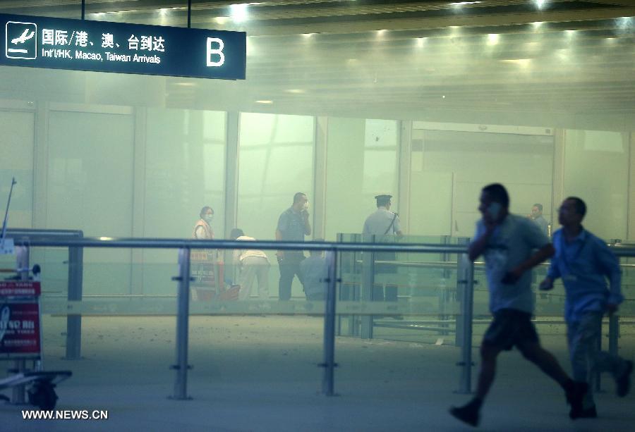 Medical workers and policemen work at an explosion site in T3 terminal of the Beijing Capital International Airport in Beijing, capital of China, July 20, 2013. The explosion occured around 6:30 p.m. near the B exit of the terminal. According to eyewitnesses, a disabled person ignited bombs on himself. The casualty is unknown yet. (Xinhua/Chen Jianli)