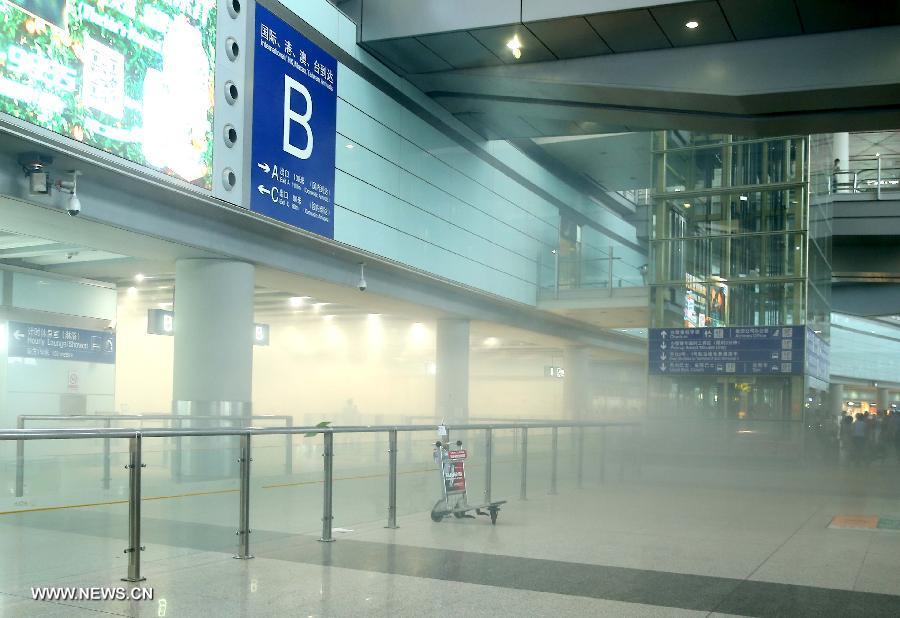 Smoke is seen after an explosion in T3 terminal at the Beijing Capital International Airport in Beijing, capital of China, July 20, 2013. The explosion occured at around 6:24 p.m. on Saturday near the B exit of the terminal. According to eyewitnesses, a disabled person ignited a bomb on himself. The casualty is unknown yet. (Xinhua/Chen Jianli)