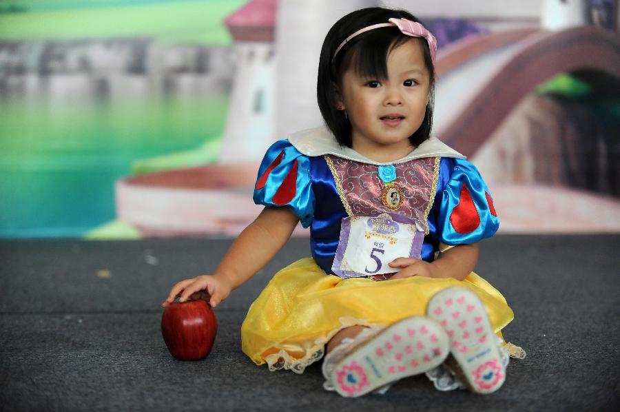 A little girl competes in the final of "Sofia the First" Little Princess Recruitment in south China's Hong Kong, July 21, 2013. "Sofia the First" is a television cartoon series produced by Disney. In total 25 little girls competed during the final recruitment organized by Disney Junior channel. (Xinhua/Zhao Yusi)