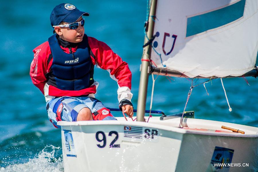 Jaime participates in Op (Optimist) races in Sao Sebastiao Channel during the 40th International Sailing Week 2013 Ilhabela Monotypes in Ilhabela, Brazil, July 20, 2013. (Xinhua/Marcos Mendez)