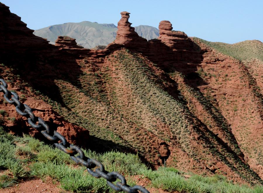 Photo taken on July 20, 2013 shows the scenery of Danxia landform at Pingshan Lake scenic area in Zhangye City, northwest China's Gansu Province. Danxia, which means "rosy cloud", is a special landform formed from reddish sandstone that has been eroded over time into a series of mountains surrounded by curvaceous cliffs and many unusual rock formations. (Xinhua/Wang Jiang)