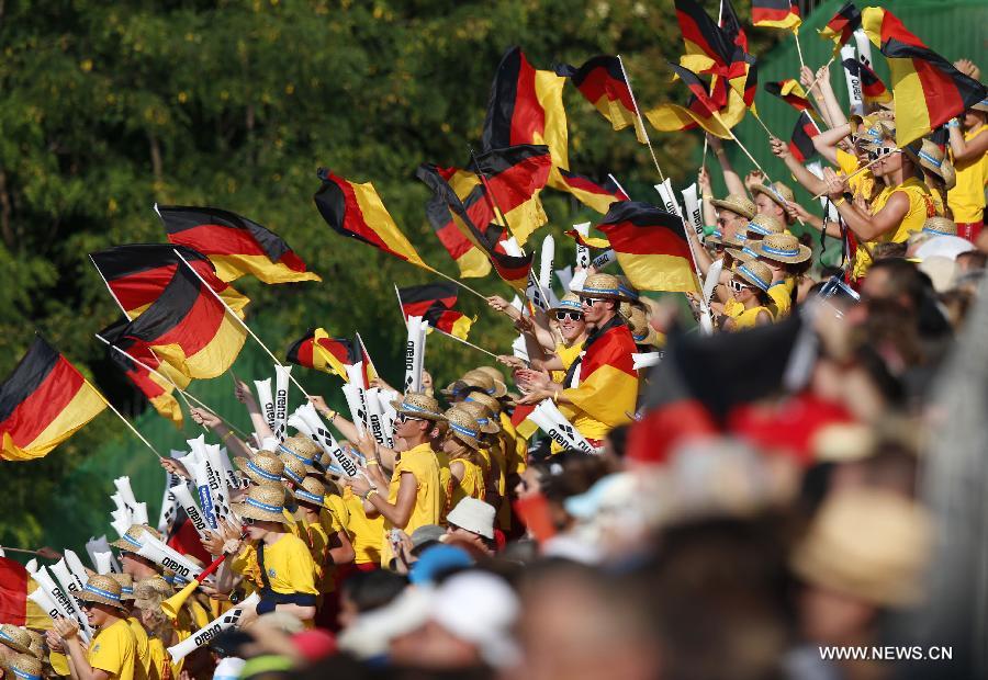 German supporters cheer for Sascha Klein and Patrick Hausding during the men's 10m synchro platform final of the Diving competition in the 15th FINA World Championships at the Piscina Municipal de Montjuic in Barcelona, Spain, on July 21, 2013. Sascha Klein and Patrick Hausding claimed the title with a total socre of 461.46 points. (Xinhua/Wang Lili)