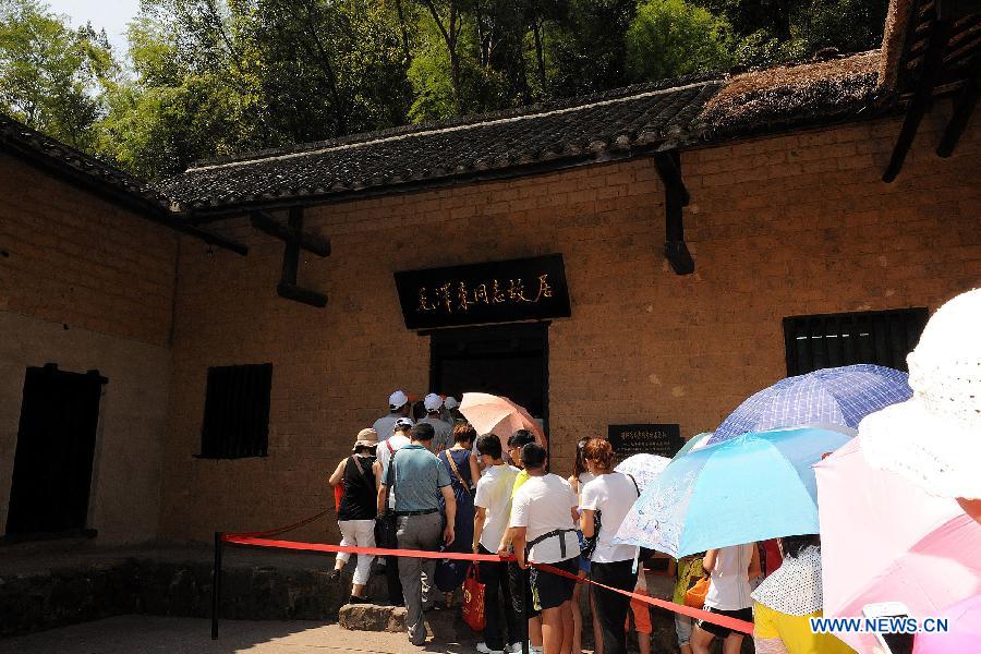 Tourists visit the Former Residence of Chairman Mao Zedong located in Shaoshan Township of Xiangtan City, central China's Hunan Province, July 19, 2013. This year marks the 120th Anniversary of Mao Zedong's Birth, many tourists come to the Former Residence of Chairman Mao Zedong which is a national site for patriotic education.(Xinhua/He Changjun)