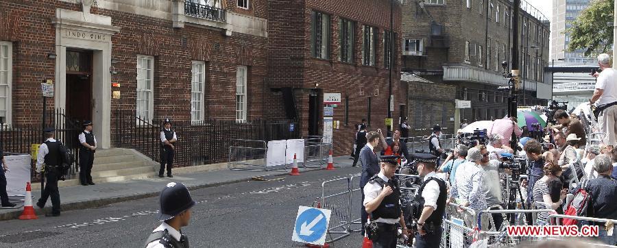 Reporters gather outside the Lindo Wing of St. Mary's Hospital in London, July 22, 2013. The nation awaits news of a new royal baby as Prince William's wife Kate has gone into labour and been admitted to St. Mary's Hospital for the birth of the couple's first child. (Xinhua/Yin Gang)