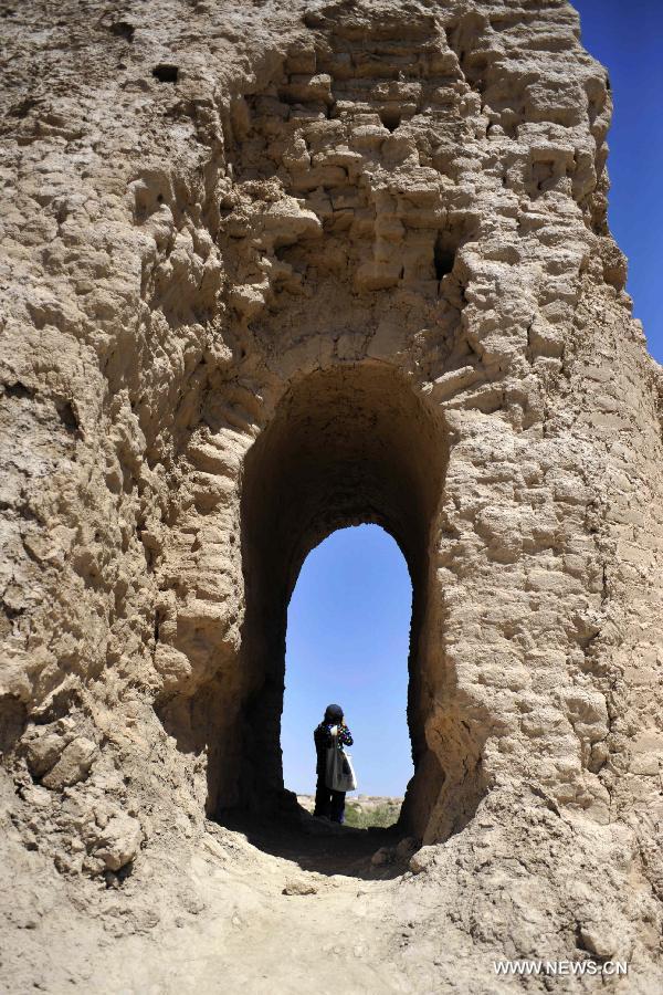 A tourist visits the ruins of Suoyang City in Guazhou County, northwest China's Gansu Province, July 22, 2013. The ruins of Suoyang City is ready to meet the evaluation from experts for its access to the World Cultural Heritage list in August. Suoyang, which dates back to the Han Dynasty (202 BC-220 AD), was an ancient city on the "Silk Road", a route that facilitated Eurasia trade and cultural exchanges in ancient times. (Xinhua/Chen Bin)  