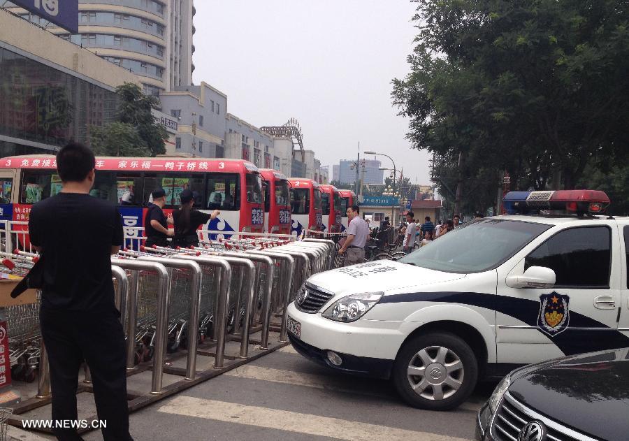 Police cars are seen outside the Carrefour store where a knife attack occurred in Maliandao, downtown Beijing, China. A knife-wielding man injured four people on Monday in the Carrefour store, police confirmed. The suspect, a Beijing local surnamed Wang, was captured on the spot, police said. The injured have been taken to hospital. (Xinhua/Ma Jing)