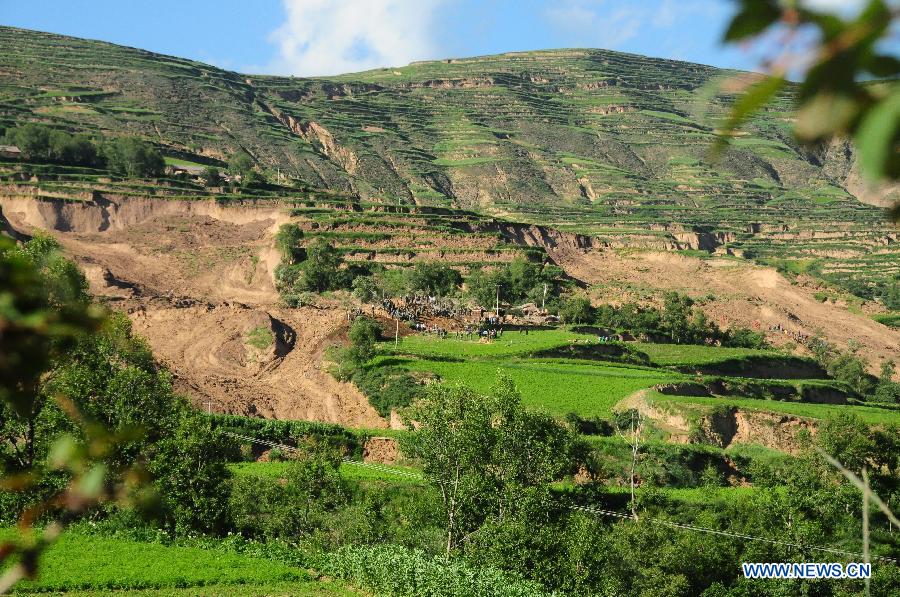 Photo taken on July 22, 2013 shows the scene of a landslide triggered by a 6.6-magnitude quake in Yongguang Village, Meichuan Town, Minxian County, northwest China's Gansu Province. At least nine villagers in Yongguang were killed in the quake and 12 others were burried in the landslide. The rescue work is underway. (Xinhua/Tu Guoxi)